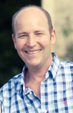 Tim Stafford outdoors smiling at the camera.